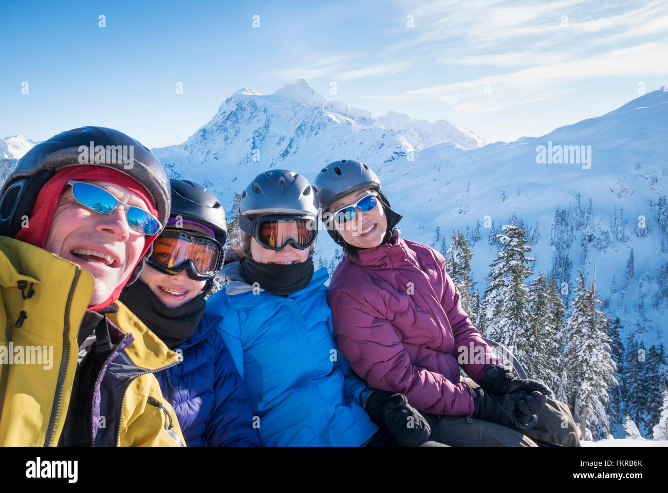 Family riding ski lift Stock Photo