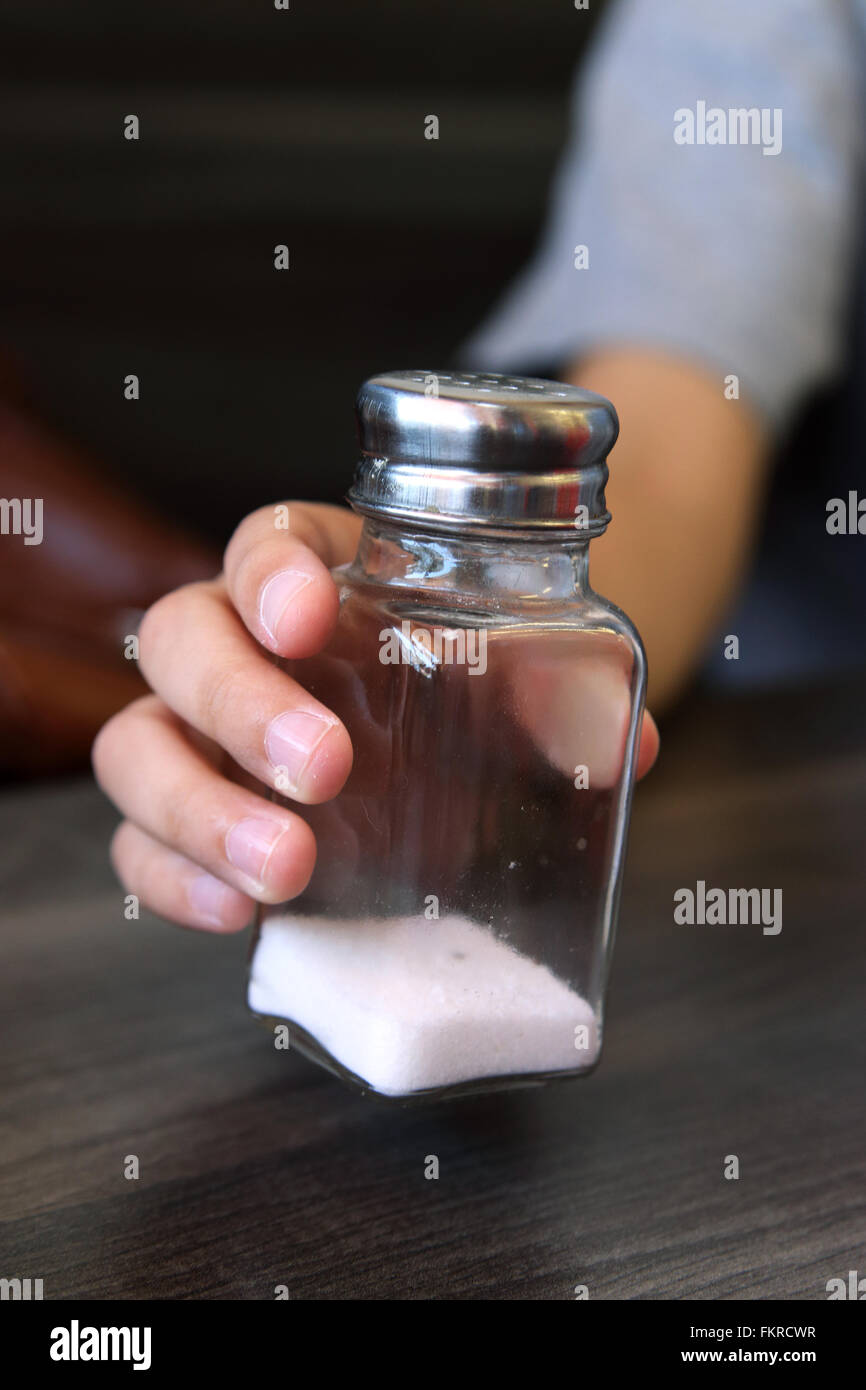 https://c8.alamy.com/comp/FKRCWR/right-hand-holding-salt-shaker-FKRCWR.jpg