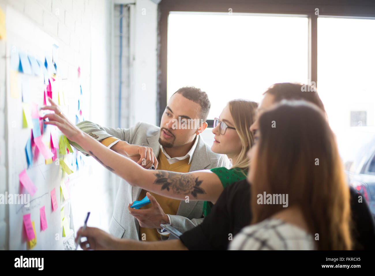 Business people using adhesive notes in office Stock Photo