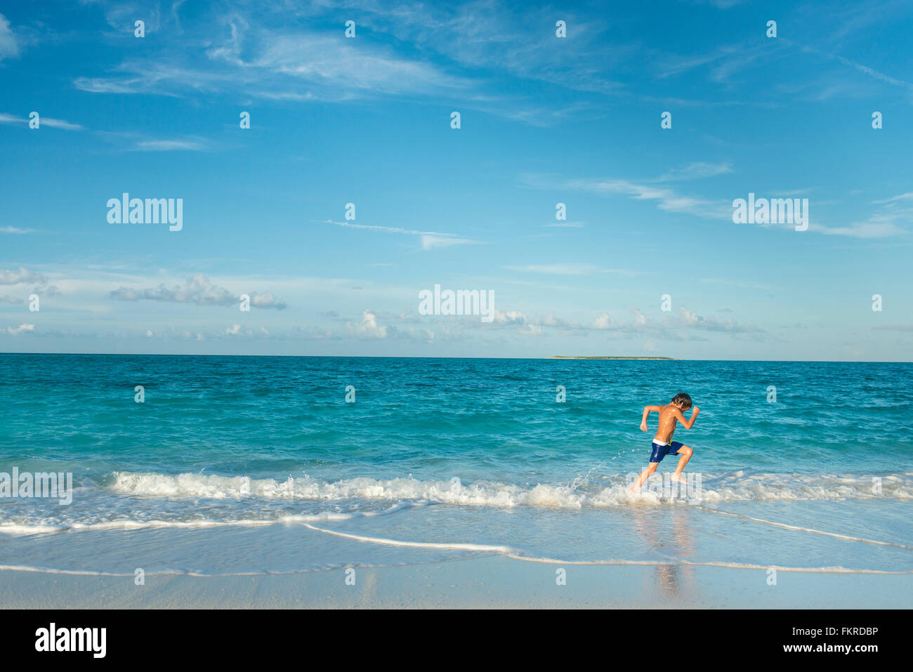 Mixed race children running blue sky hi-res stock photography and ...