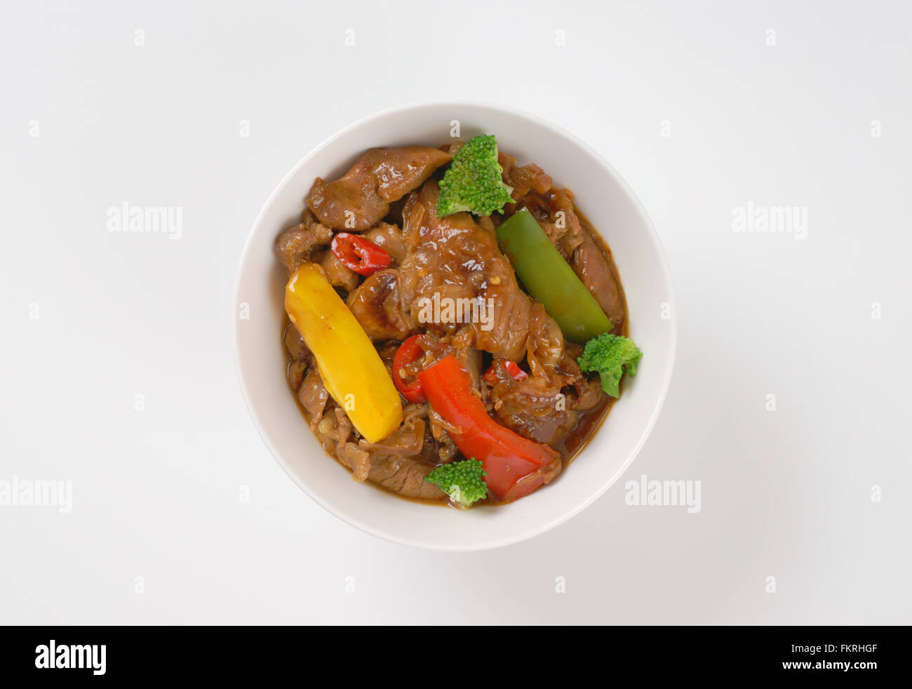 bowl of pan roasted meat and vegetables on white background Stock Photo ...