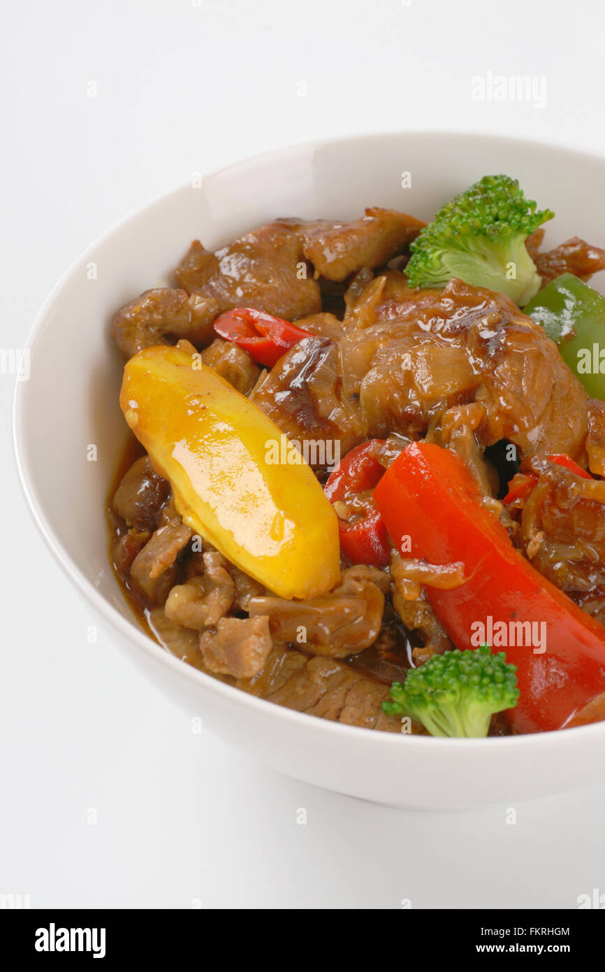 bowl of pan roasted meat and vegetables on white background Stock Photo ...