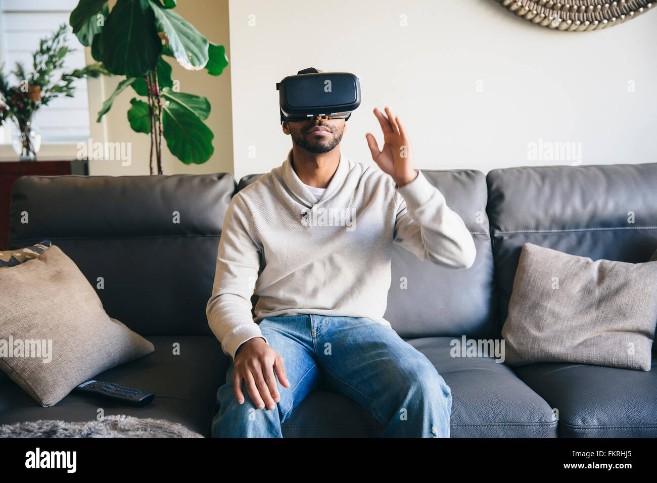 Mixed race man using virtual reality goggles Stock Photo