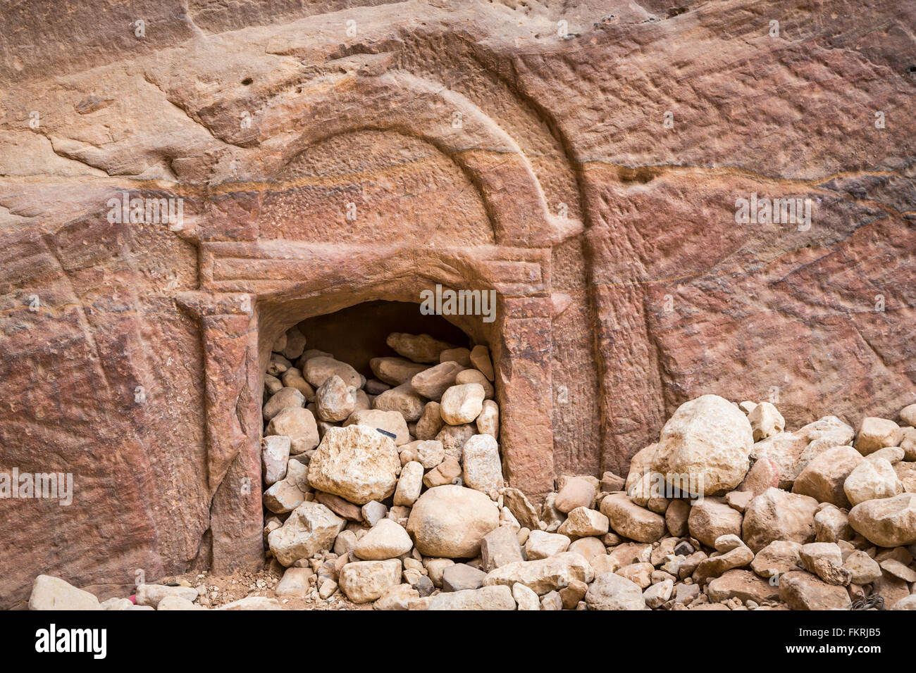 A small cave opening in the narrow siq passage entrance to Petra, Hashemite Kingdom of Jordan. Stock Photo