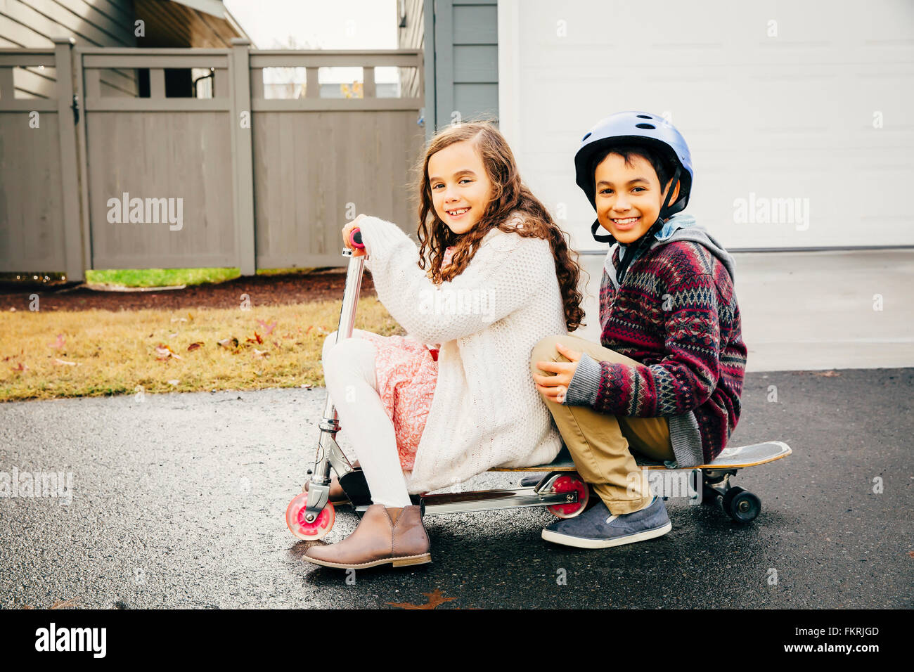 Mixed race children playing outdoors Stock Photo
