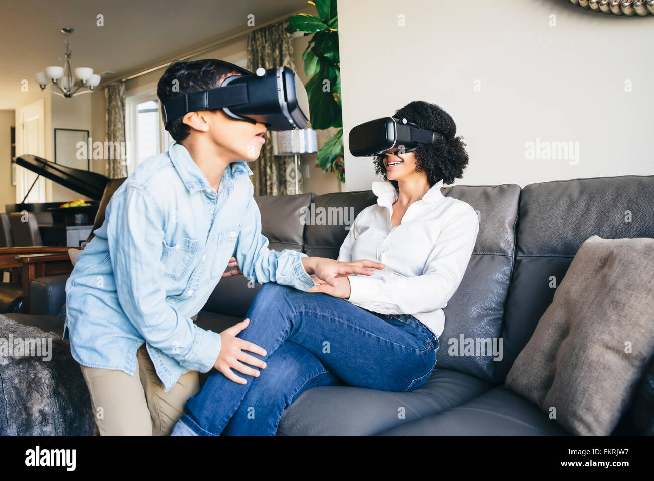 Mother and son using virtual reality goggles Stock Photo
