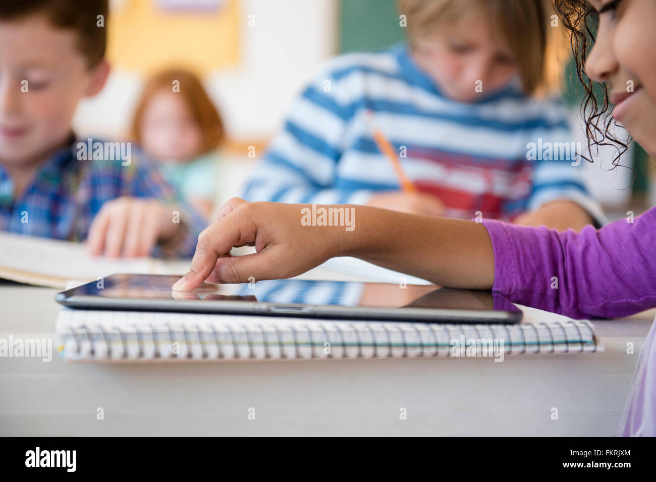 Student using digital tablet in classroom Stock Photo