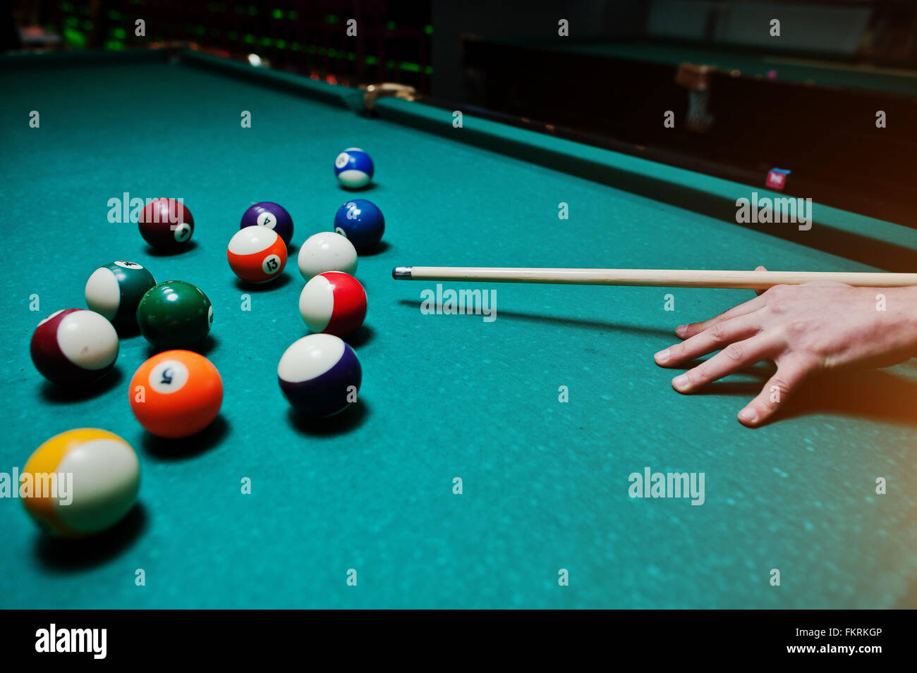 Hand man holding billiard cue to shoot balls Stock Photo - Alamy