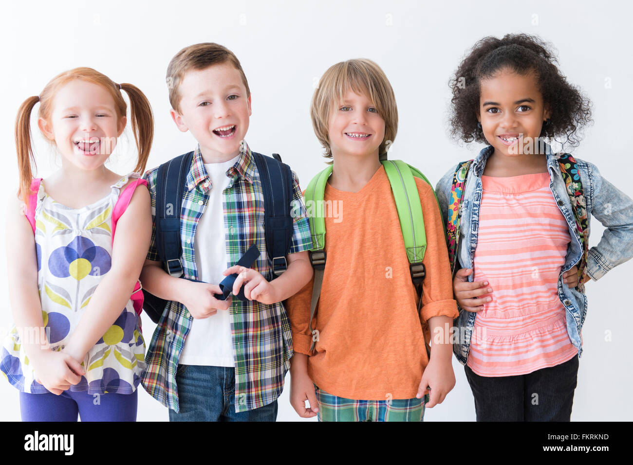 Smiling children wearing backpacks Stock Photo