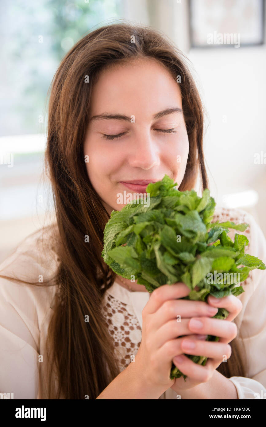 Native American woman smelling herbs Stock Photo