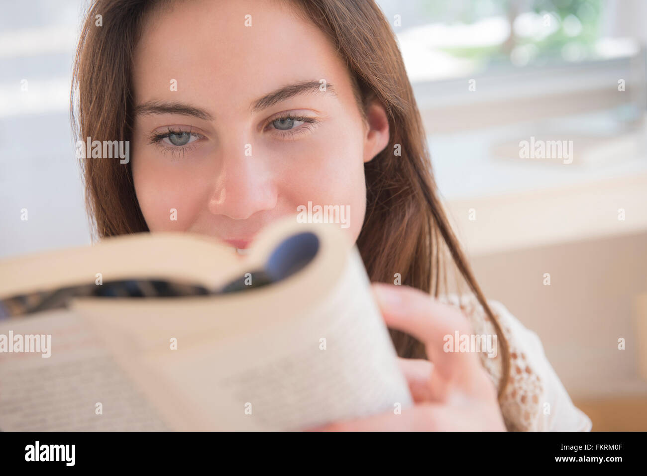 Native American woman reading book Stock Photo