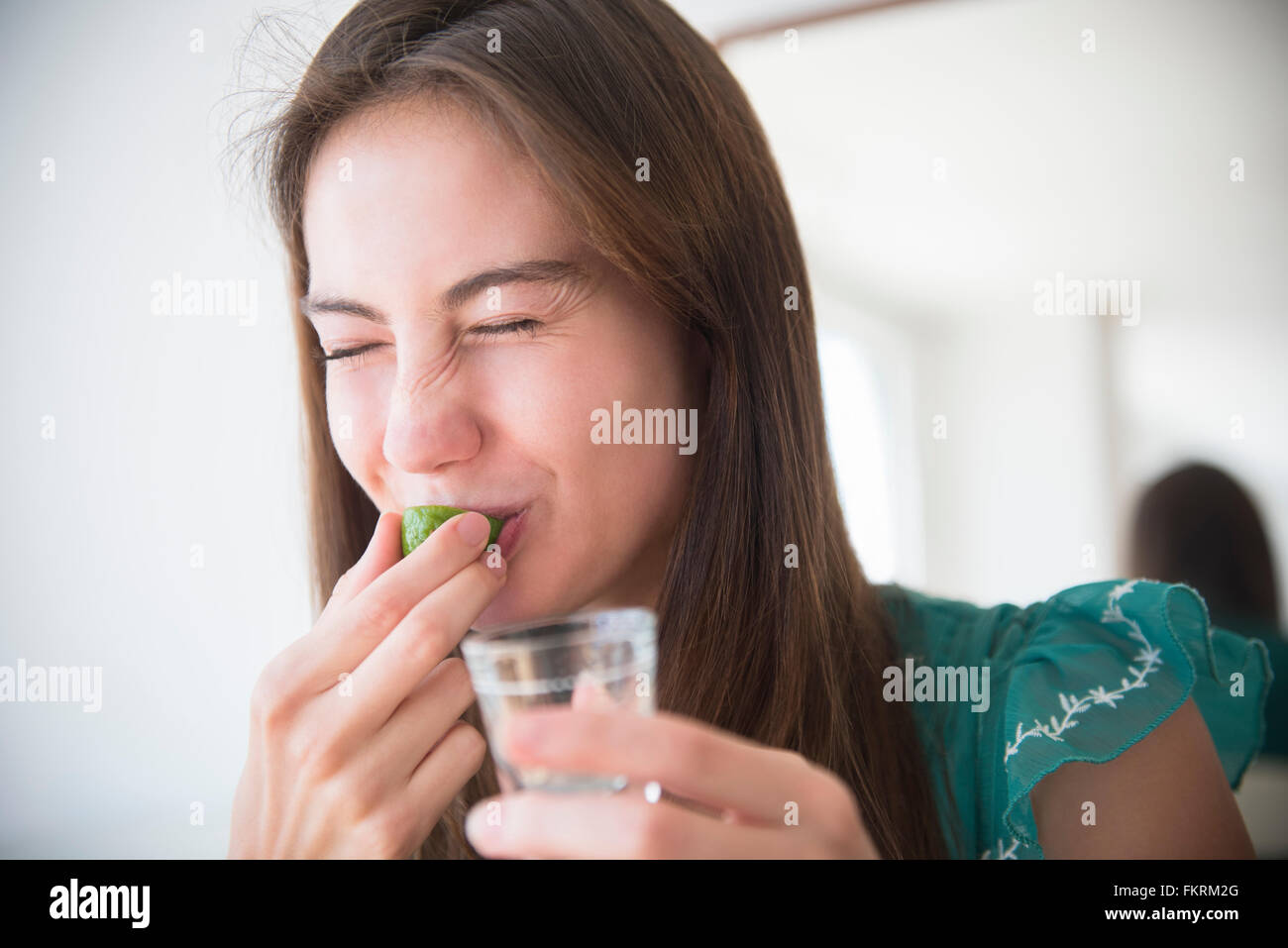 Native American woman drinking tequila shot Stock Photo