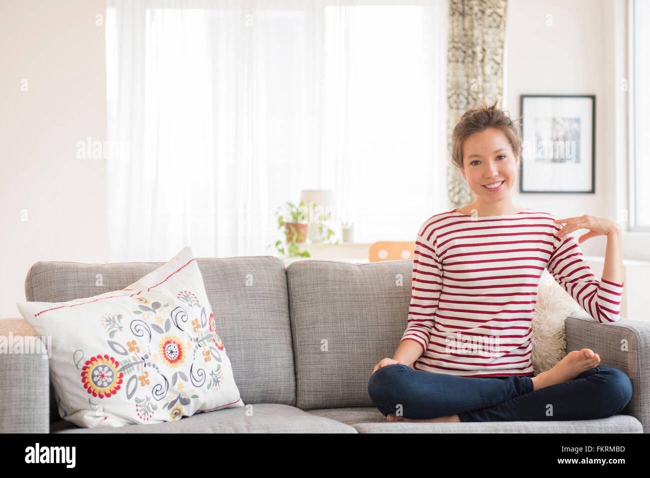 Woman sitting cross legged on sofa hi-res stock photography and images ...