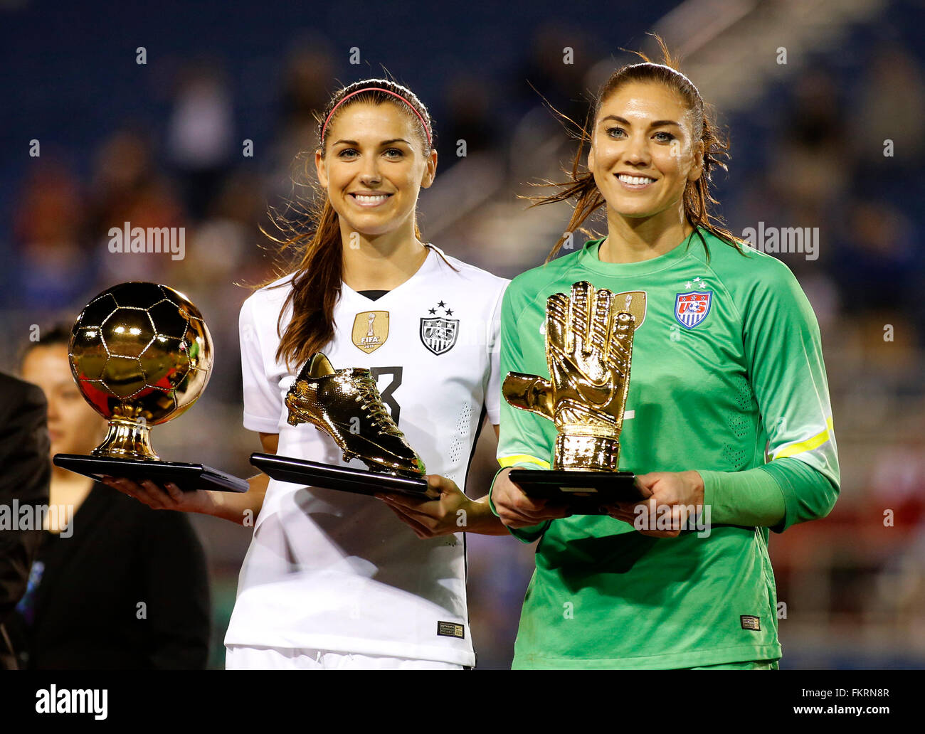 Hope Solo (R) of the USA holds her golden glove award while Alex Morgan (L) holds the golden boot and golden ball awards after the USA defeated Germany 2-1 in the She Believes Cup at the FAU Stadium in Boca Raton, Florida USA, 09 March 2016. Photo: Joe Skipper/dpa Stock Photo