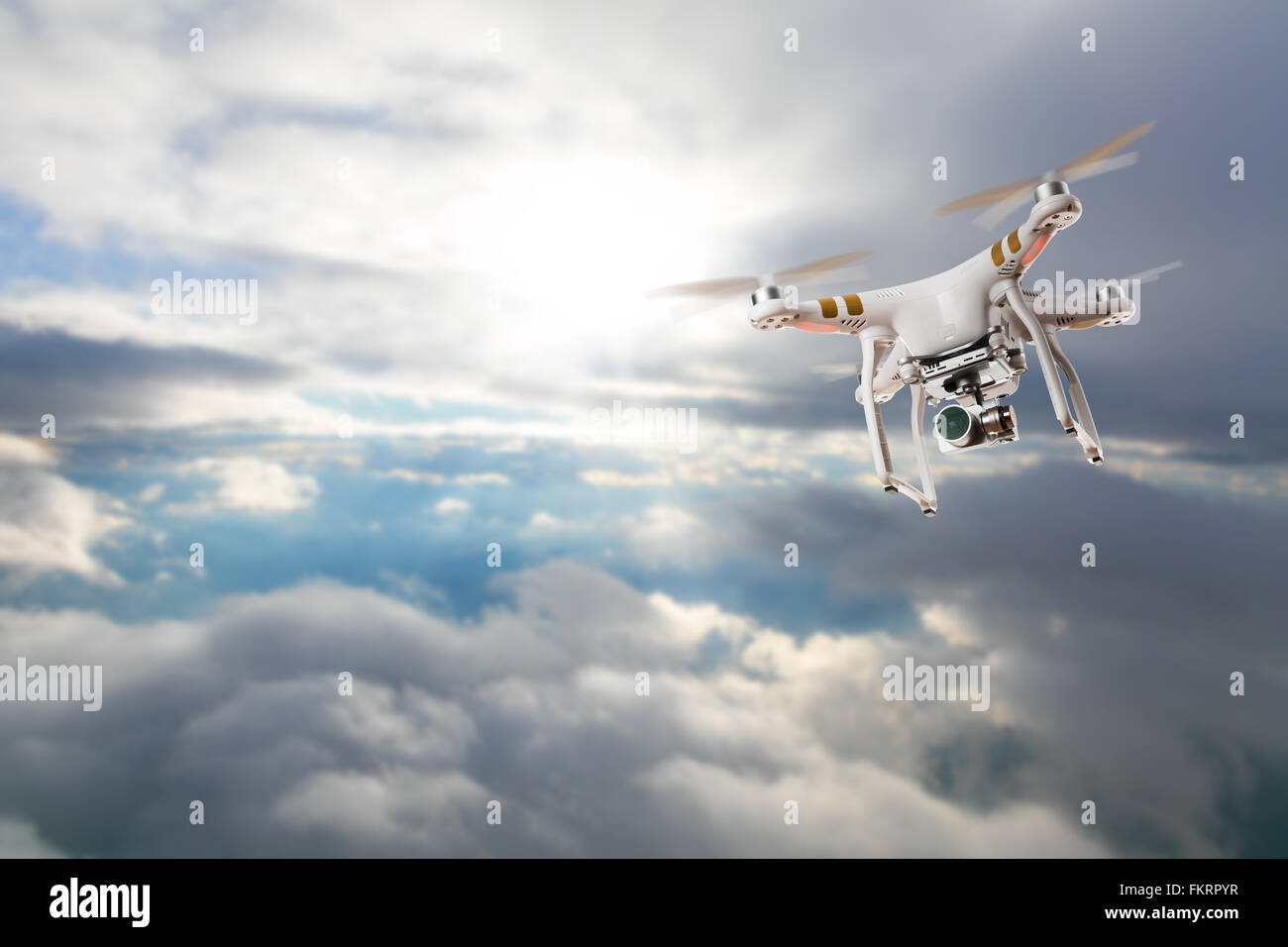 Drone for industrial works flying above clouds Stock Photo