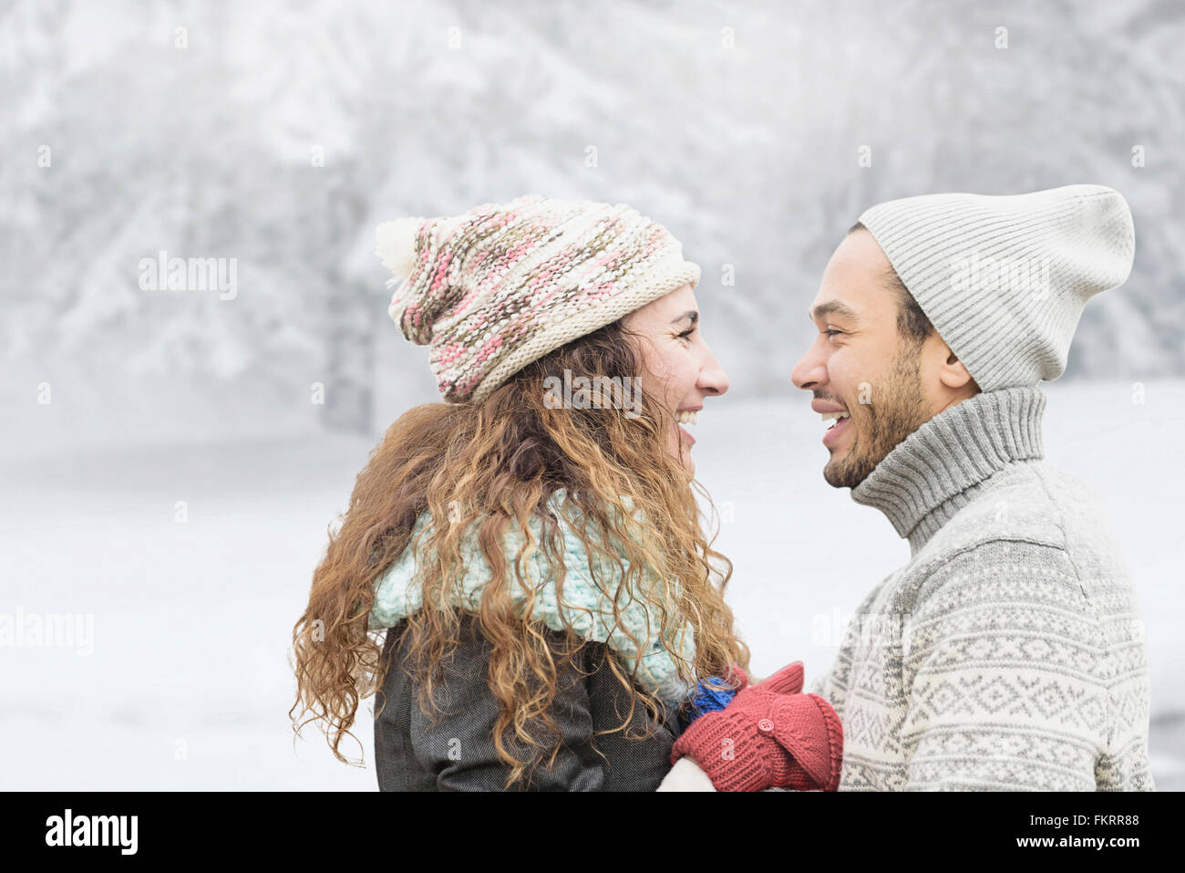 Couple smiling in snow Stock Photo