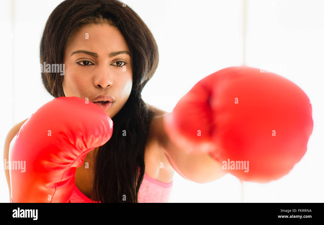 Mixed race boxer punching Stock Photo Alamy