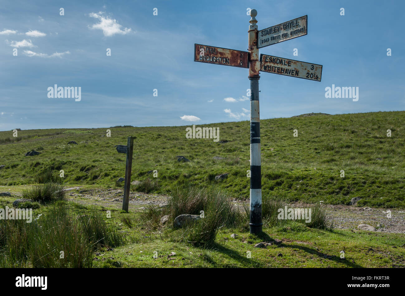 Signpost and waymarker at the start of the Devoke Water track Stock Photo