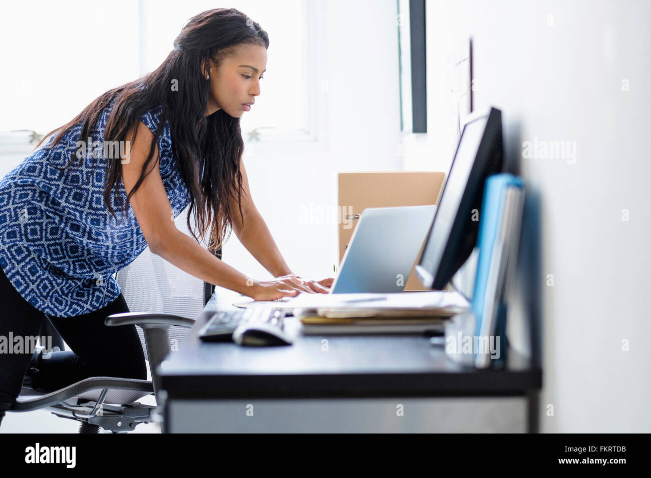 Mixed race businesswoman working in office Stock Photo