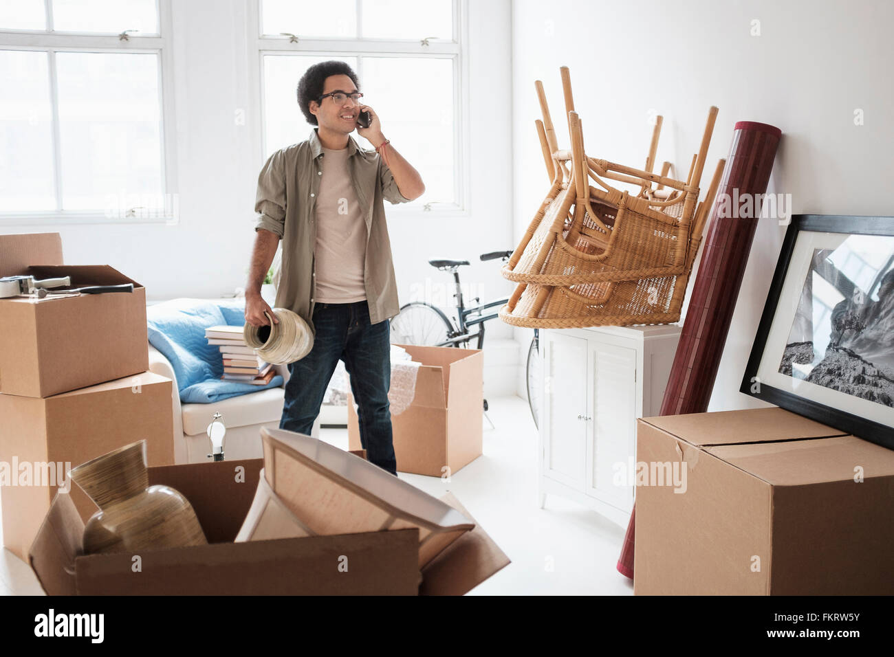 Mixed race man unpacking in new home Stock Photo