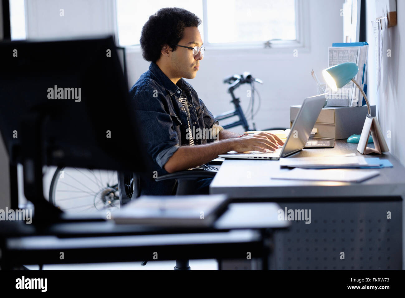 Mixed race businessman working in office Stock Photo