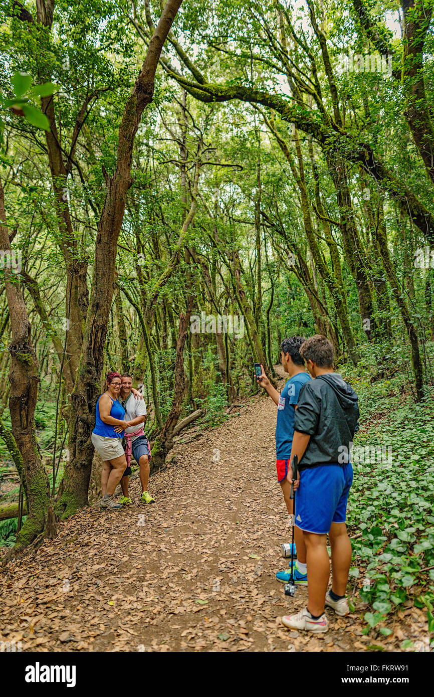 Hikers taking photos. Garajonay National Park is covered by dense laurel forests. La Gomera, Canary Islands, Spain. Stock Photo
