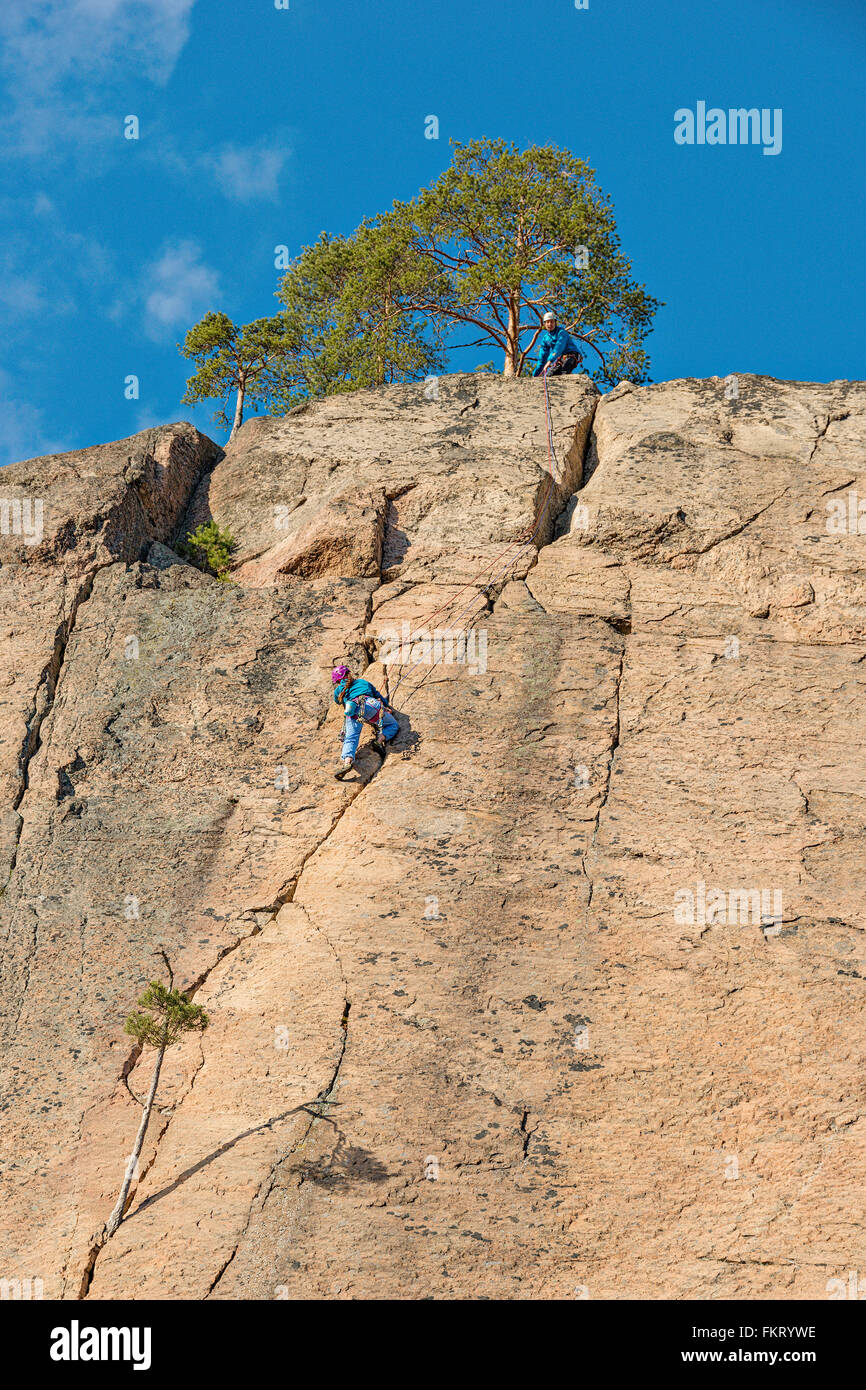 Rock climbers at Olhava cliff. Repovesi National Park, Finland Stock