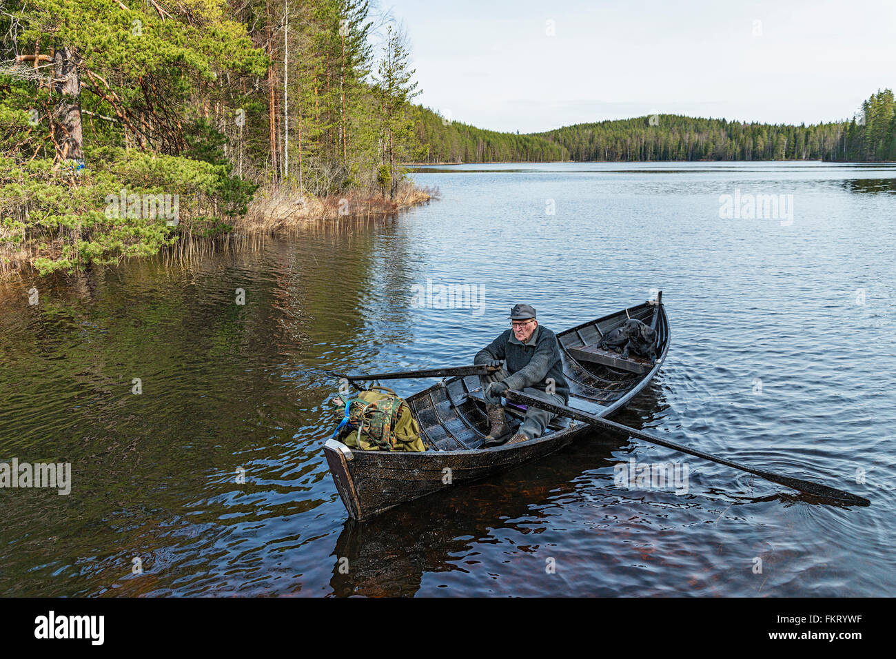 Man with a rowing boat in Repovesi National Park, Finland. Stock Photo