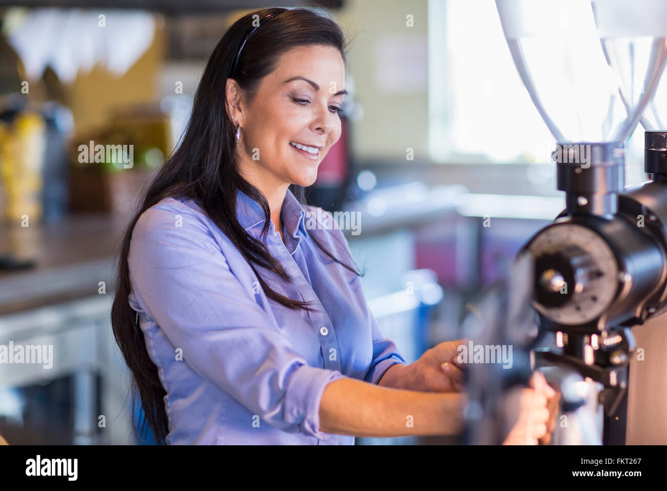 Hispanic barista making coffee in cafe Stock Photo Alamy
