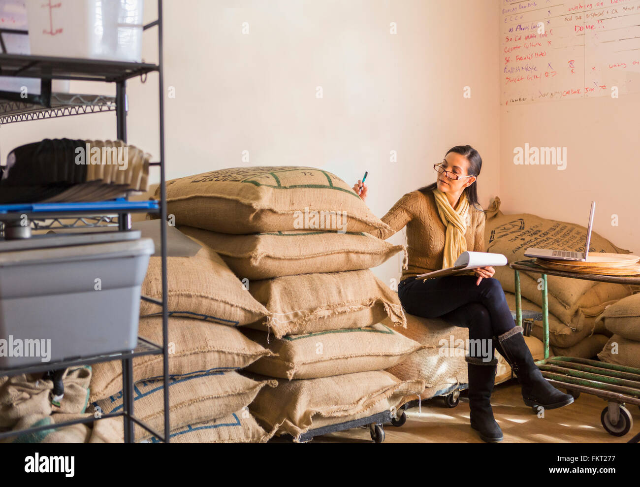 Hispanic business owner checking inventory Stock Photo