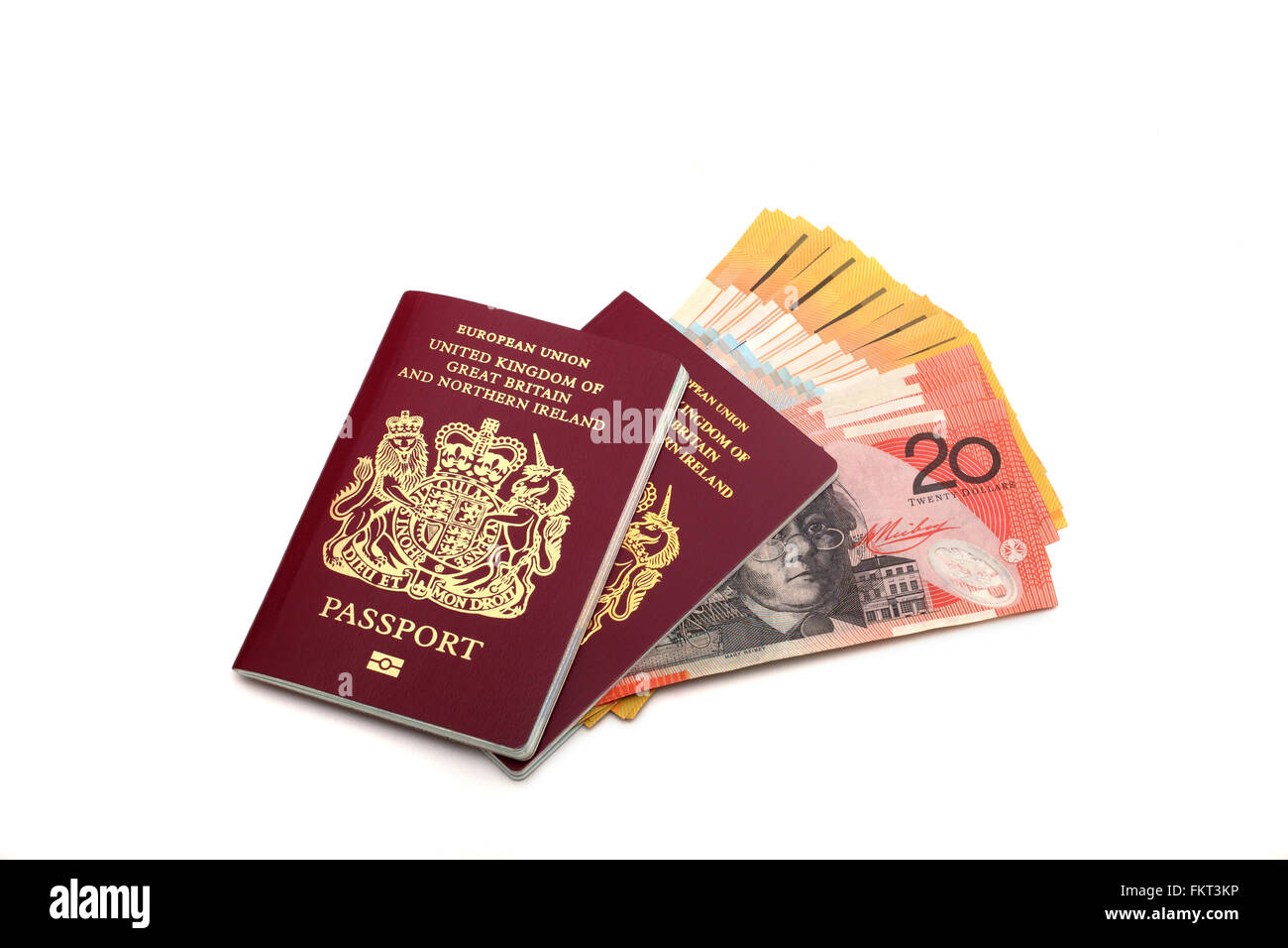 Two British EU passports laying over twenty and fifty Dollar Australian banknotes Stock Photo