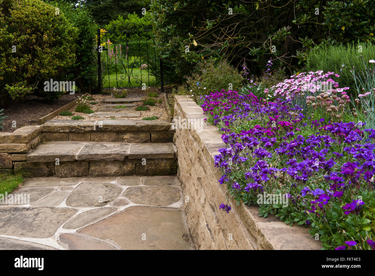 Wrought iron gate in a beautiful, traditional, designed, landscaped
