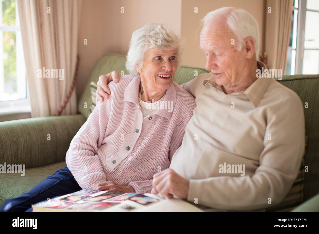 Older Caucasian couple looking at photo album Stock Photo