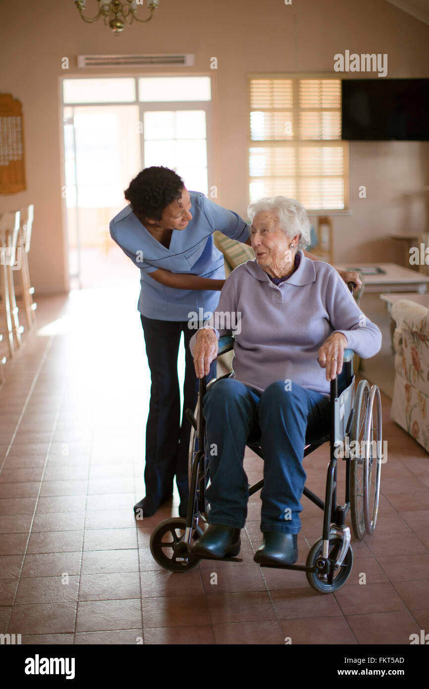 Nurse talking to patient in wheelchair Stock Photo