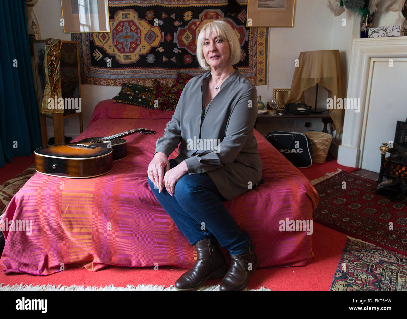 Kathy Etchingham, girlfriend of Jimi Hendrix who lived at the flat with him in 1968-69, posing on the bed at the recreated room exhibition  Featuring: Kathy Etchingham Where: London, United Kingdom When: 08 Feb 2016 Stock Photo