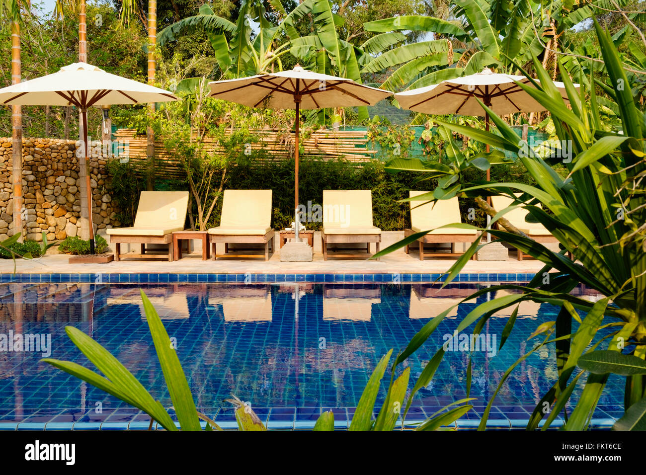 Empty lawn chairs by swimming pool Stock Photo Alamy
