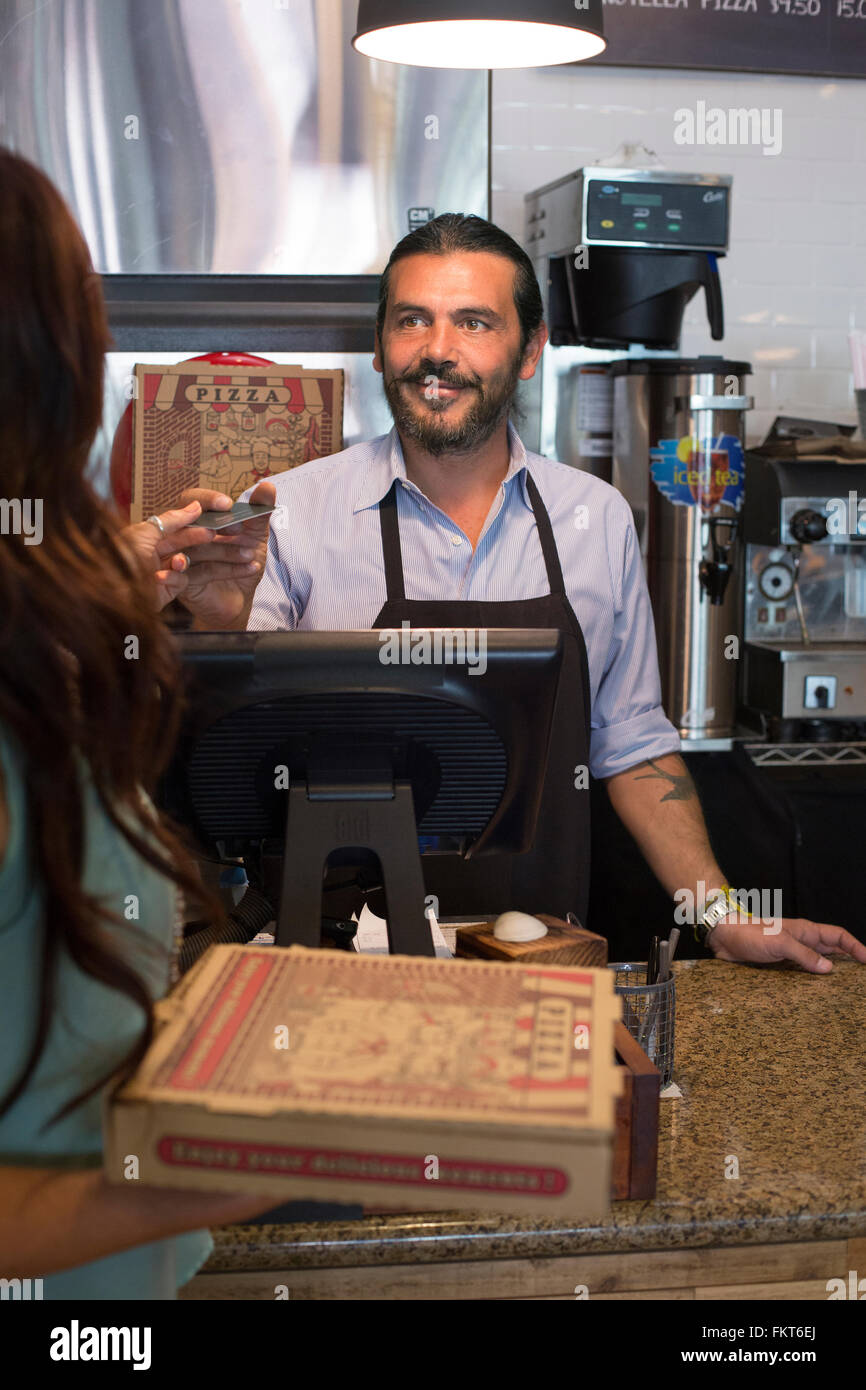 Customer purchasing pizza in cafe Stock Photo