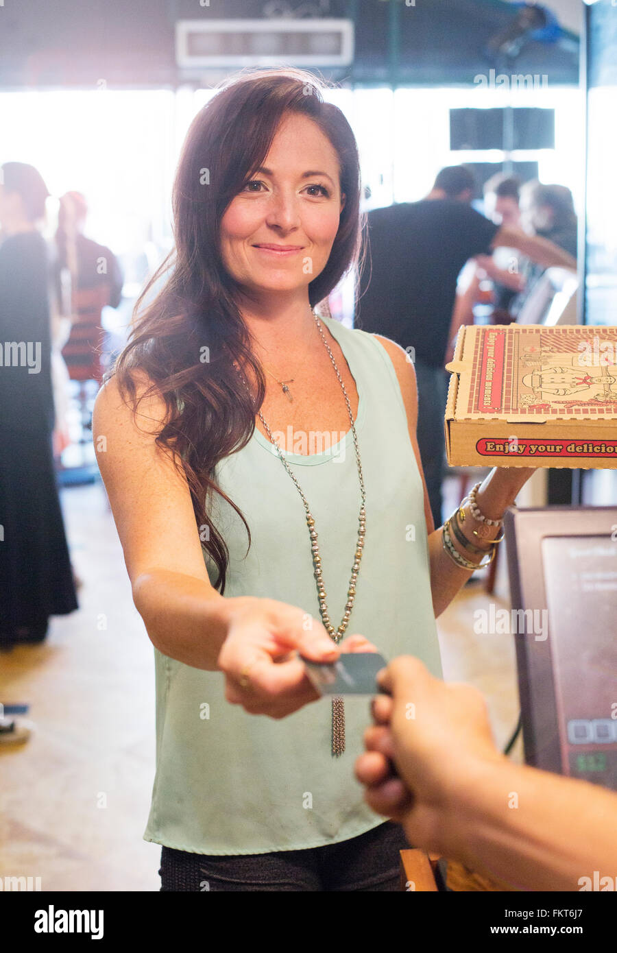 Customer purchasing pizza in cafe Stock Photo