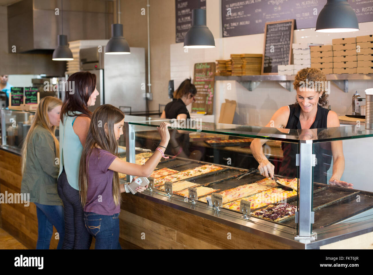 Customers choosing pizza in cafe Stock Photo