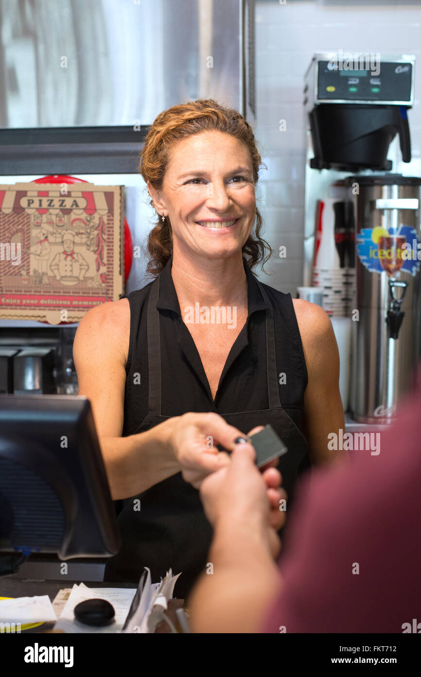 Server helping customer purchase pizza in cafe Stock Photo Alamy