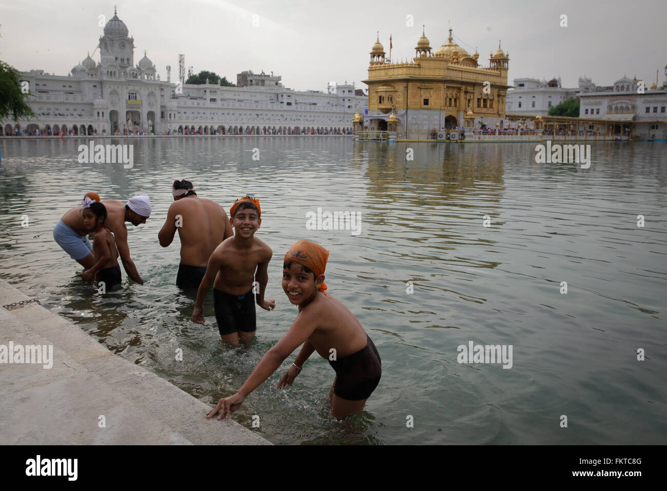 Sijs children have a bath at Golden Temple lake. Stock Photo
