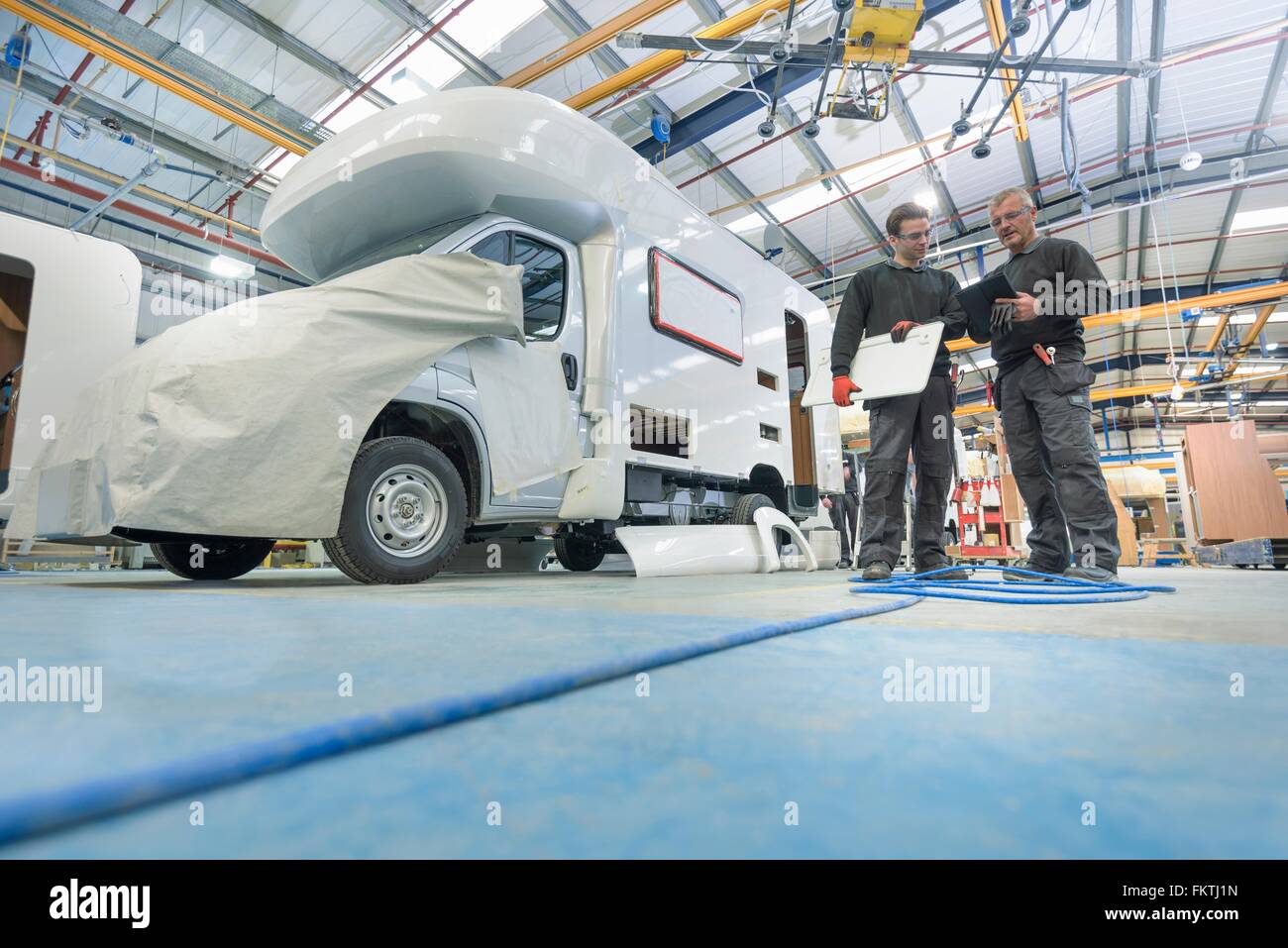 Workers on motorhome production line Stock Photo