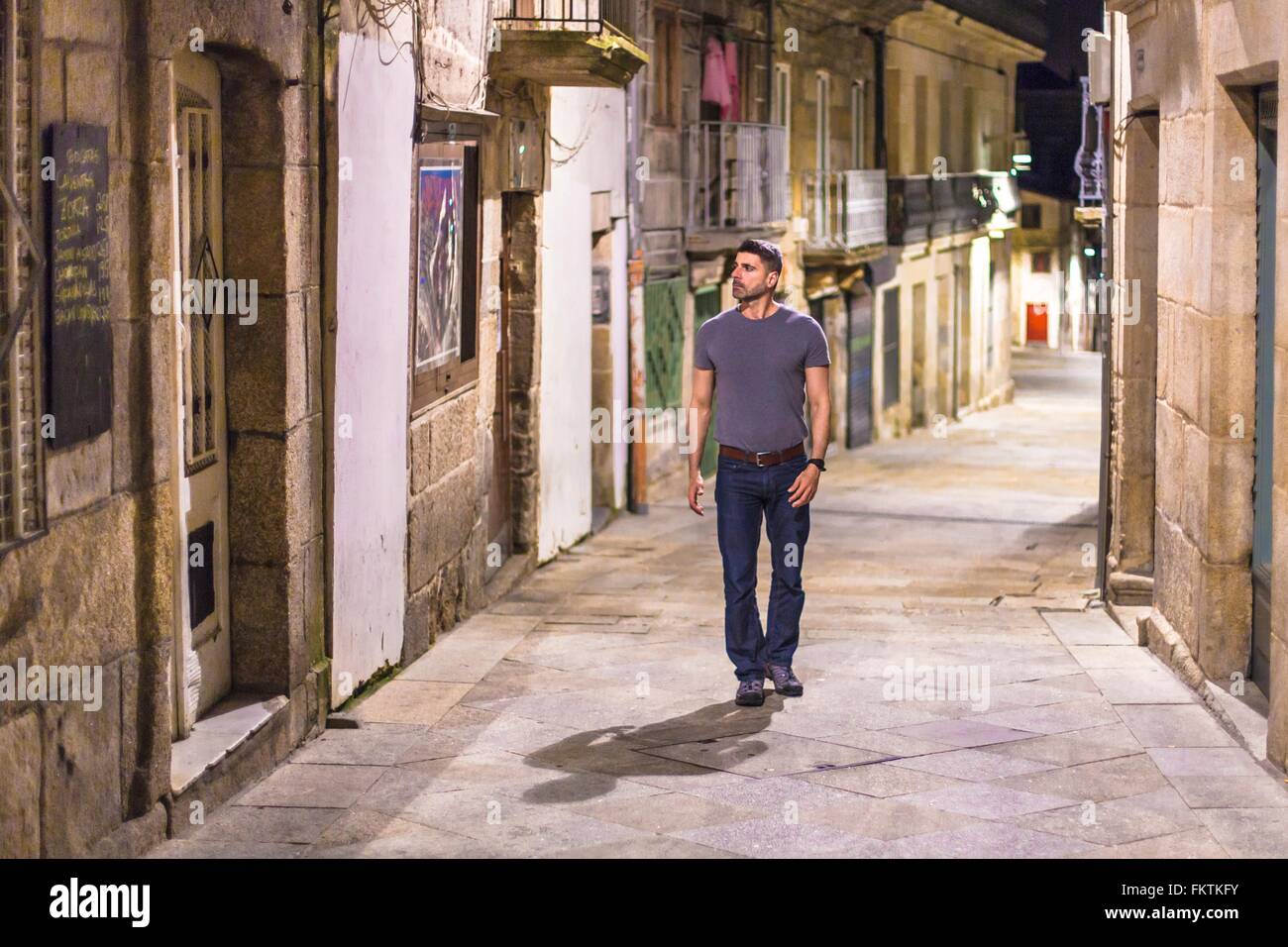 Mature man walking along street, Vigo, Spain Stock Photo