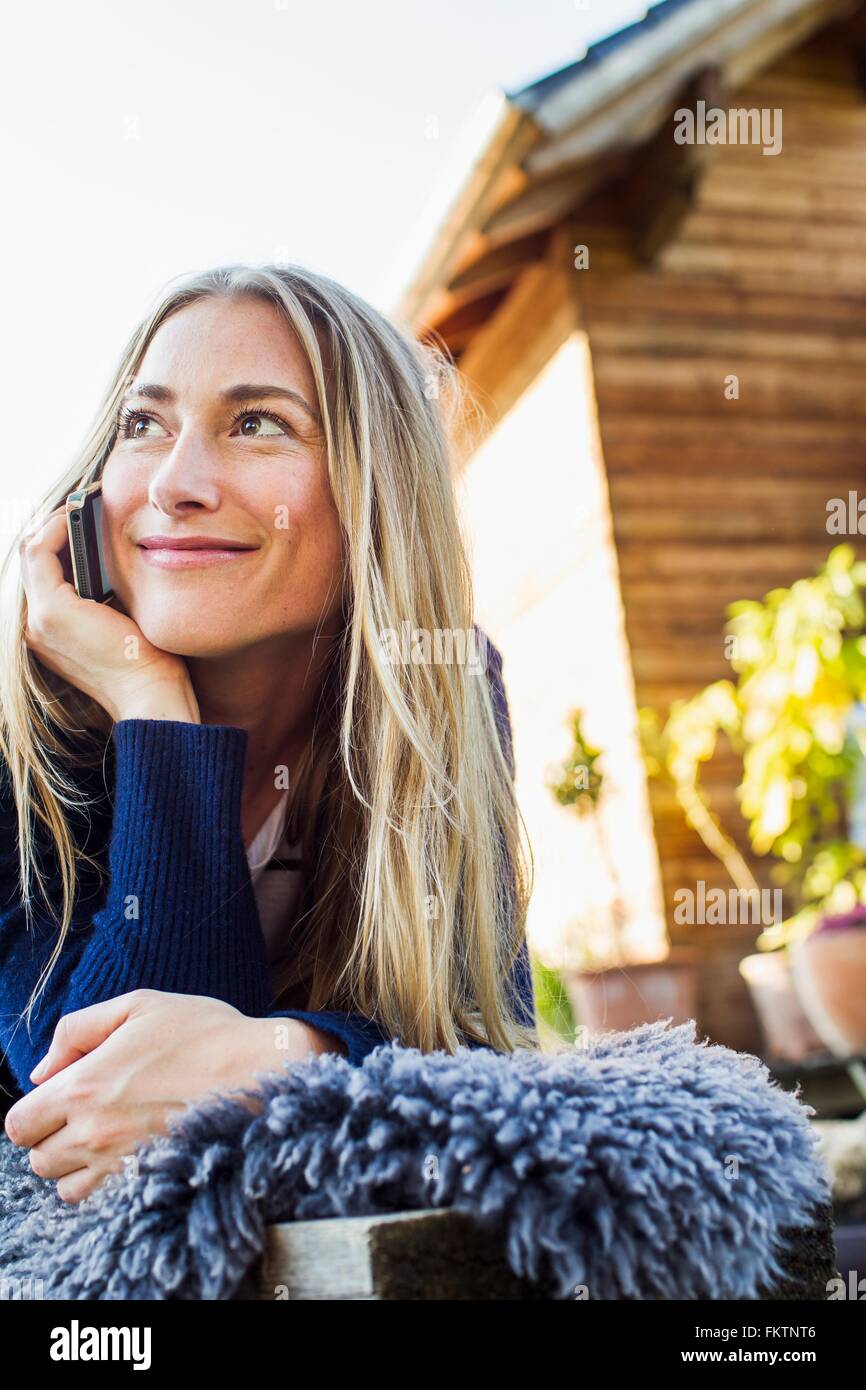 Mid adult woman on smartphone Stock Photo