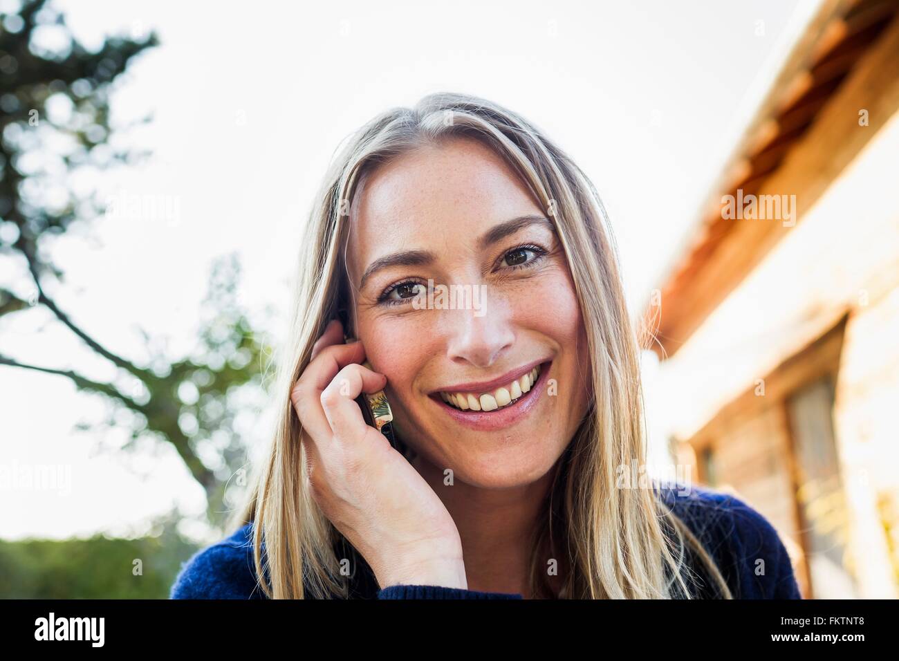 Mid adult woman on smartphone Stock Photo