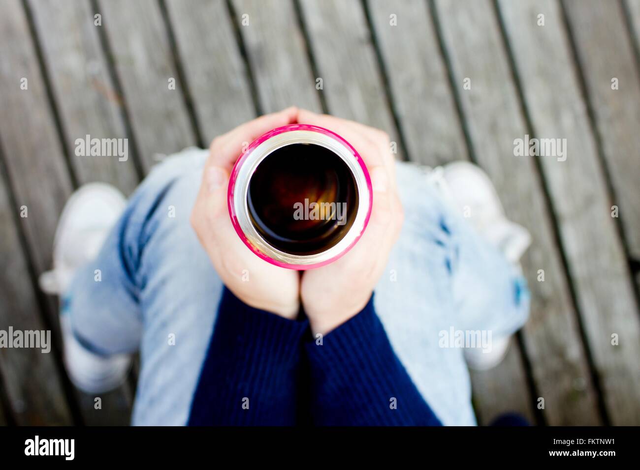 Woman holding drinks flask, high angle view Stock Photo