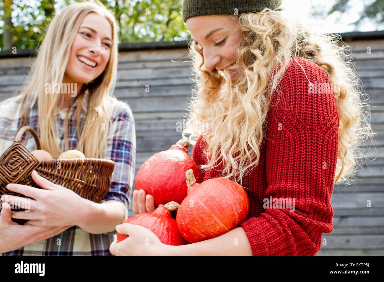 Two women holding homegrown produce Stock Photo