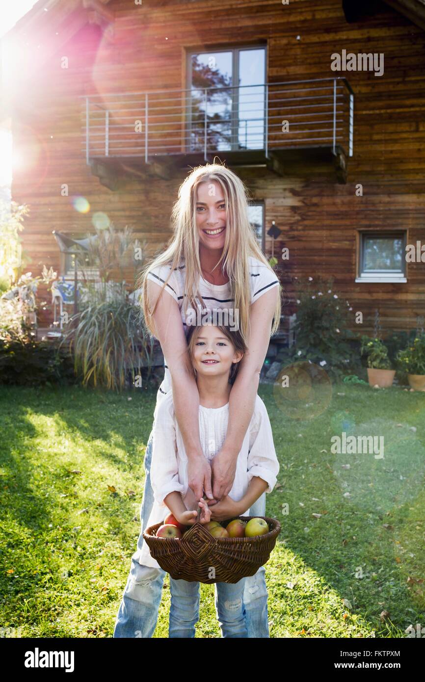 Mother and daughter holding basket   apples Stock Photo