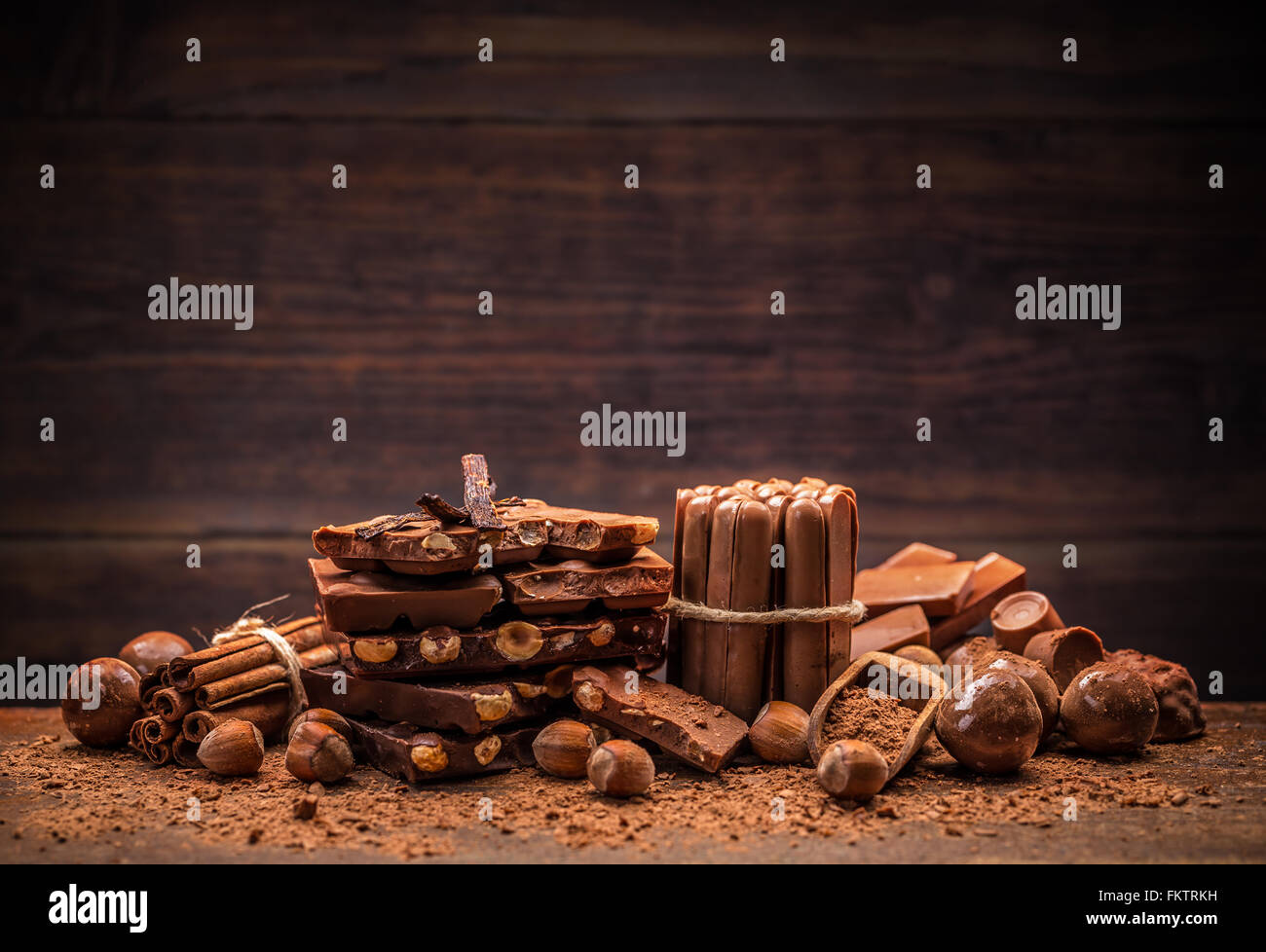 Still life with set of chocolate with nuts on wooden background Stock Photo