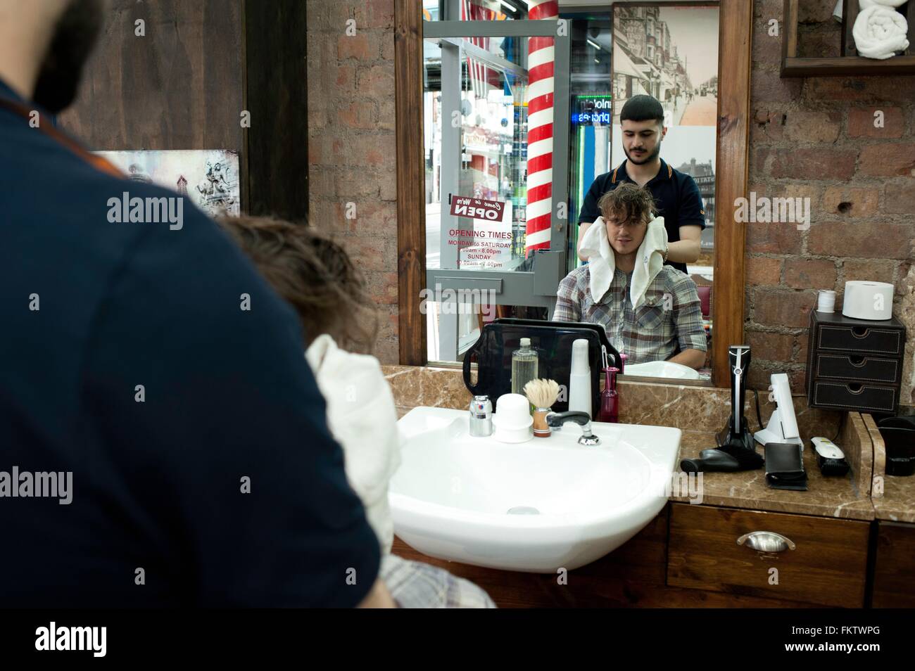 Mirror image of young man and barber in Stock Photo Alamy